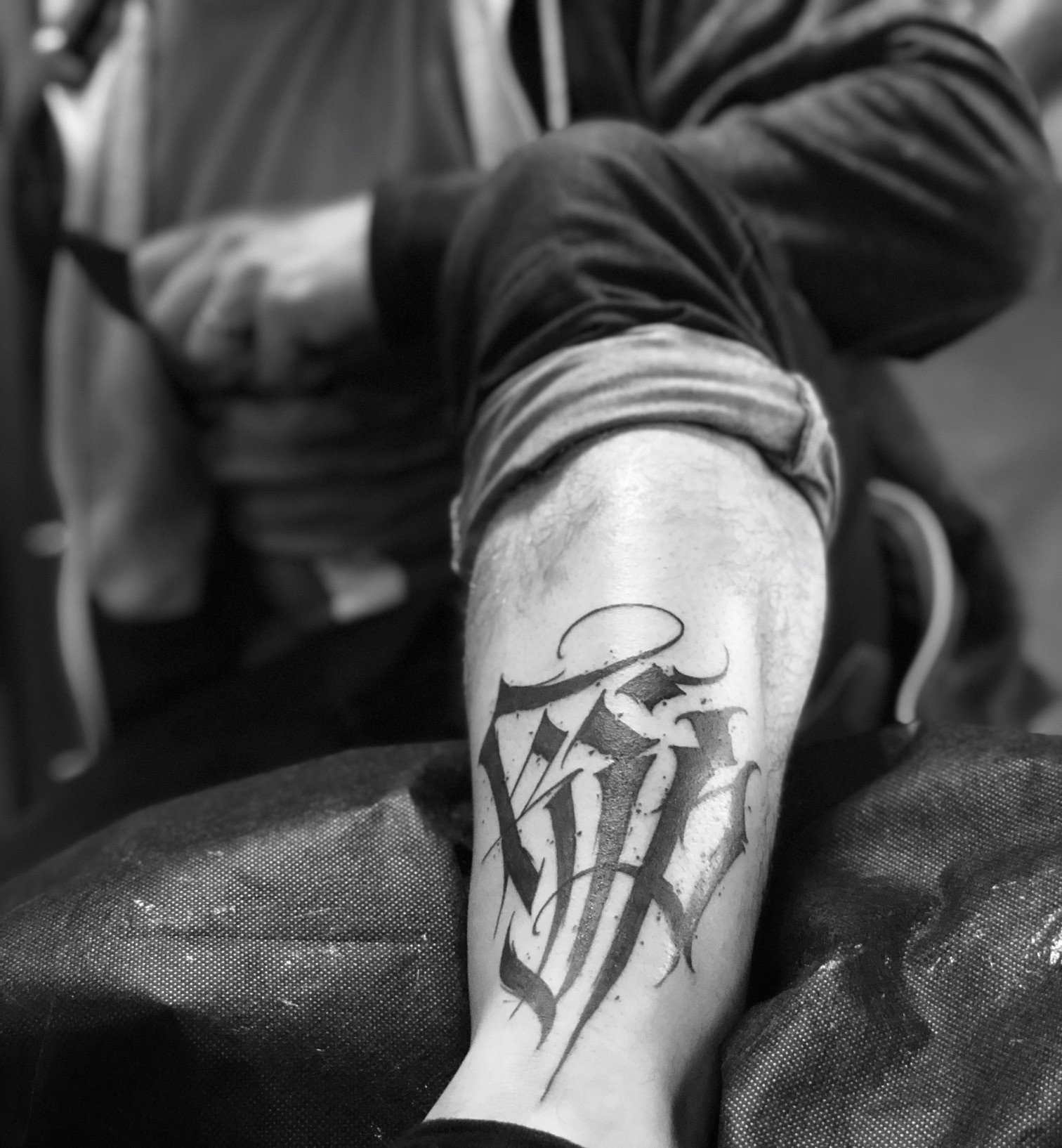 lower shin tattoo - lettering KJP done at Krakow dark times - 2019
